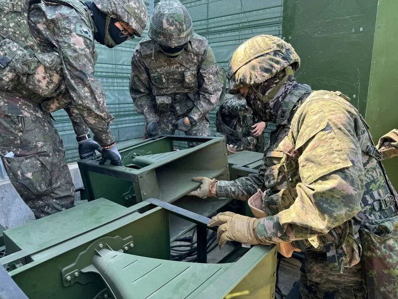 FILE PHOTO: South Korean soldiers work on a loudspeaker that is set up for propaganda broadcasts during a military drill near the demilitarized zone separating the two Koreas in Paju